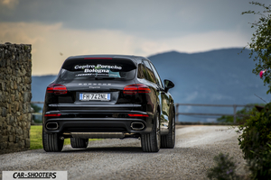 Porsche Cayenne Platinum Edition – rear three-quarter, black on a country road
