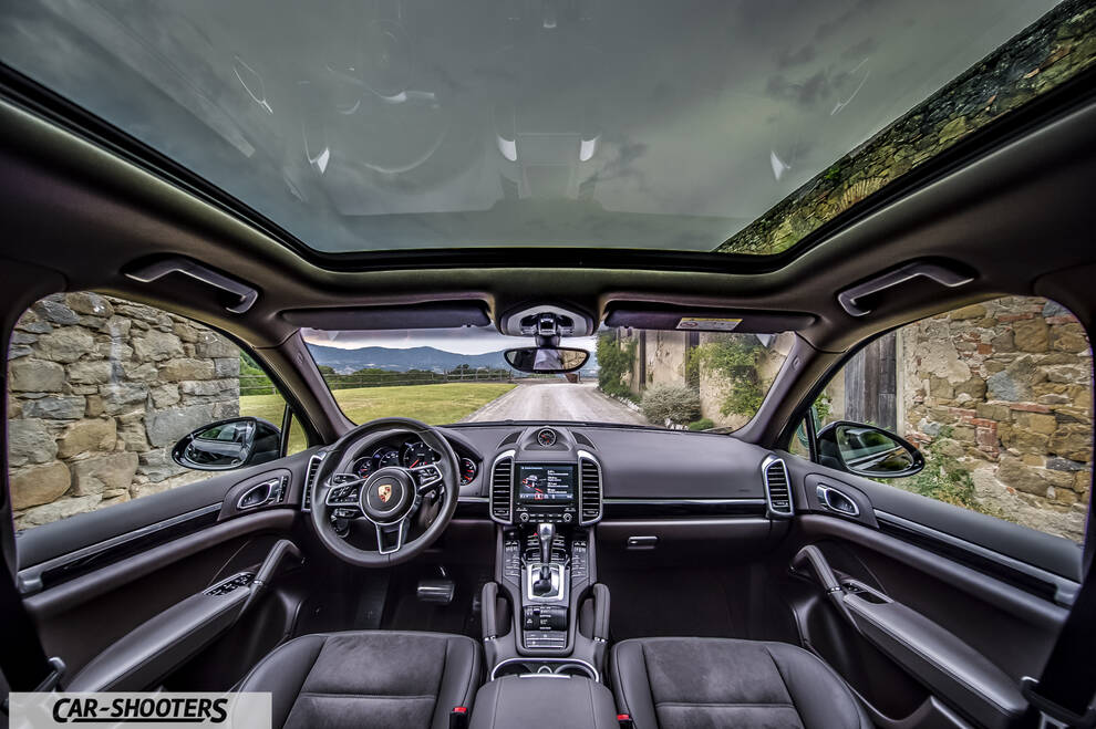 Porsche Cayenne Platinum Edition – interior, panoramic sunroof and country road view