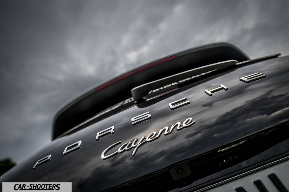 Porsche Cayenne Platinum Edition – rear view, black against a cloudy sky