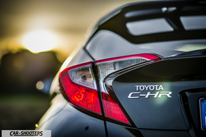 Toyota C HR – rear view, black against a sunset backdrop