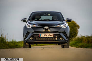 Toyota C HR – front three-quarter, dark grey metallic on a dirt road