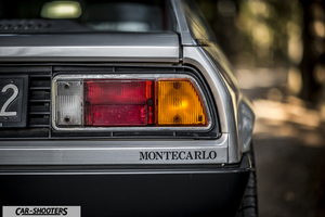 Lancia Beta Montecarlo – rear view, silver against a blurry outdoor backdrop