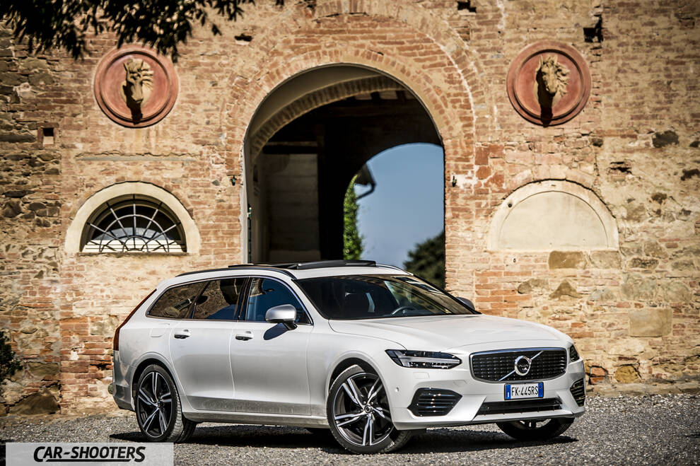 Volvo V90 T8 – front three-quarter, white against an old stone wall