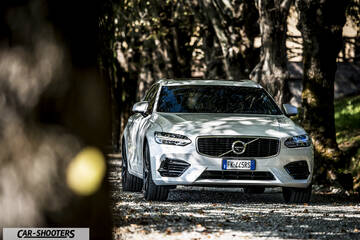 Volvo V90 T8 – front three-quarter, white on a tree-lined road
