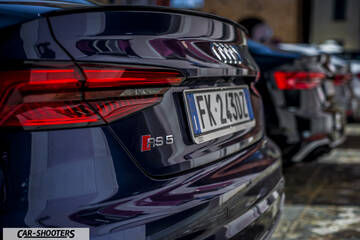 Audi – rear view, dark blue parked in a row outdoors