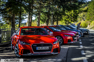 Audi – front three-quarter, red parked in a row