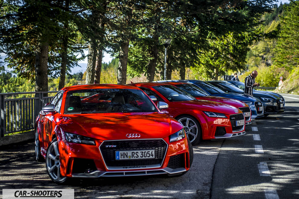 Audi – front three-quarter, red parked in a row