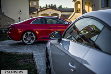 Audi – side profile, red parked outside a building
