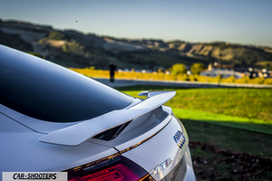 Audi – rear three-quarter, white against a hilly landscape