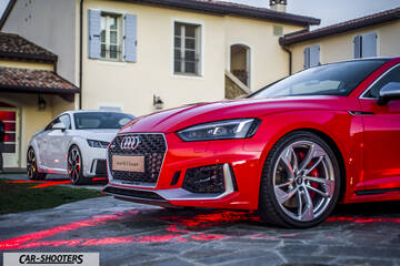 Audi – front three-quarter, red parked in a courtyard