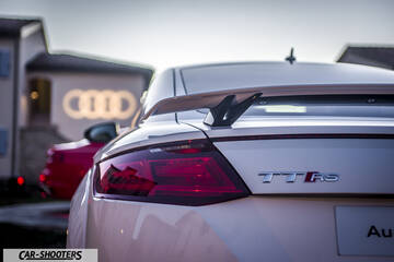 Audi – rear view, white with a rear wing parked outside