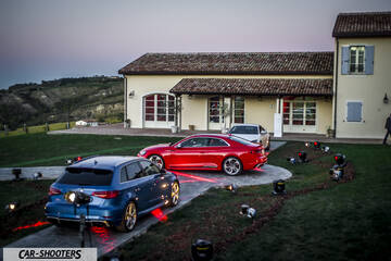 Audi – rear three-quarter, blue parked outside a large villa