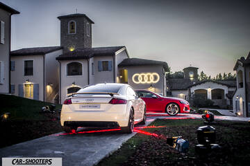 Audi – rear three-quarter, white in a European village courtyard
