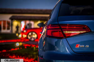 Audi – rear three-quarter, blue parked near a building