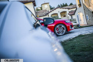 Audi – detail, foreground blur with red car in background