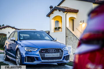 Audi – front three-quarter, blue parked near a house