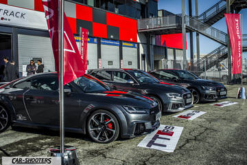 Audi – front three-quarter, grey metallic parked at a racetrack