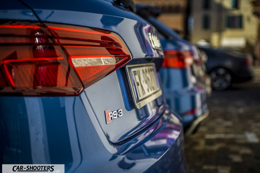 Audi – rear view, blue metallic parked in a row outdoors