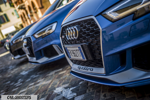 Audi – front three-quarter, blue parked on a cobblestone street