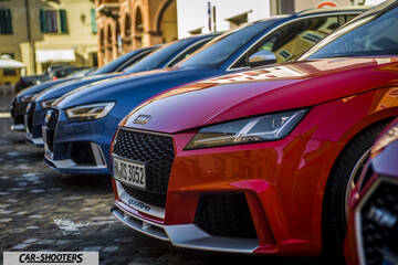 Audi – front three-quarter, red parked in a row outdoors