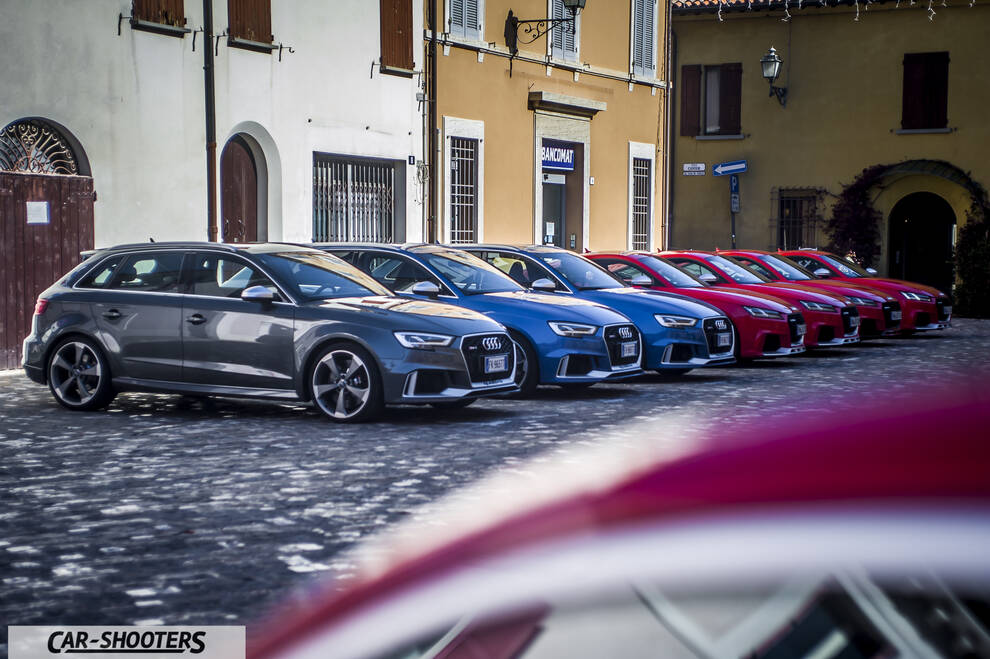 Audi – front three-quarter, grey metallic in a town square