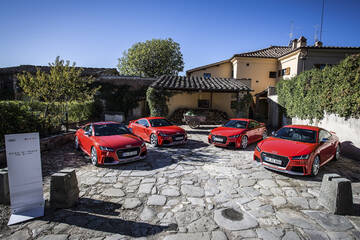 front three-quarter, red in a paved courtyard