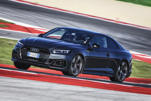 Audi – front three-quarter, dark grey metallic on a race track