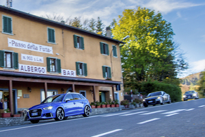 Audi – front three-quarter, blue on a road in front of a building