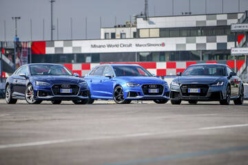 front three-quarter, blue at a racetrack paddock
