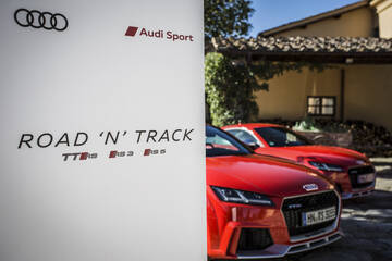 front three-quarter, red parked near a building