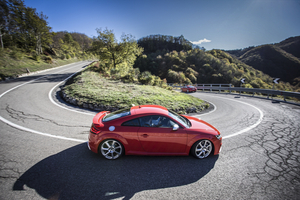 Audi – side profile, red on a winding mountain road