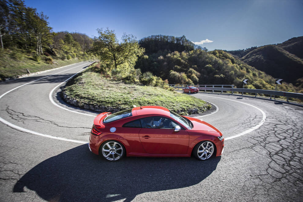 Audi – side profile, red on a winding mountain road