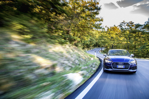 Audi – front three-quarter, blue on a winding country road