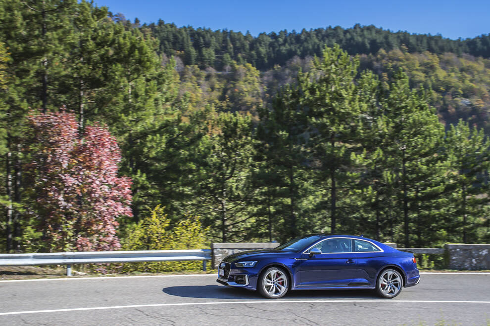Audi – side profile, blue metallic on a mountain road