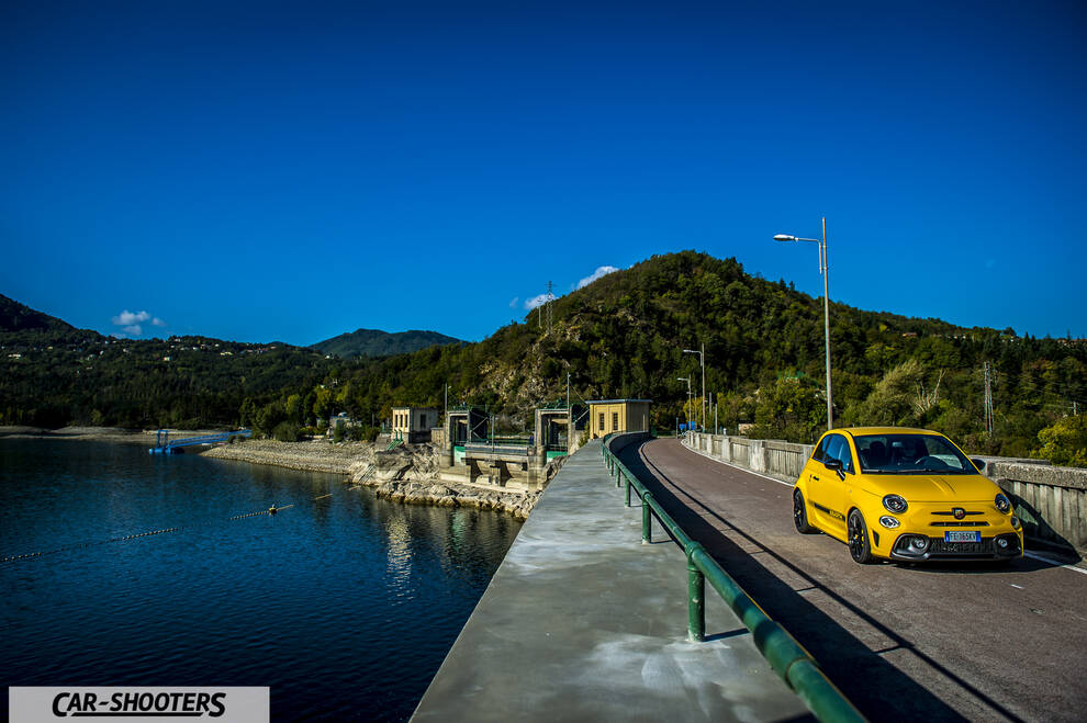 Abarth 595 Competizione – front three-quarter, yellow against a mountain backdrop