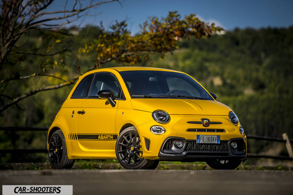 Abarth 595 Competizione – front three-quarter, yellow against a mountain backdrop