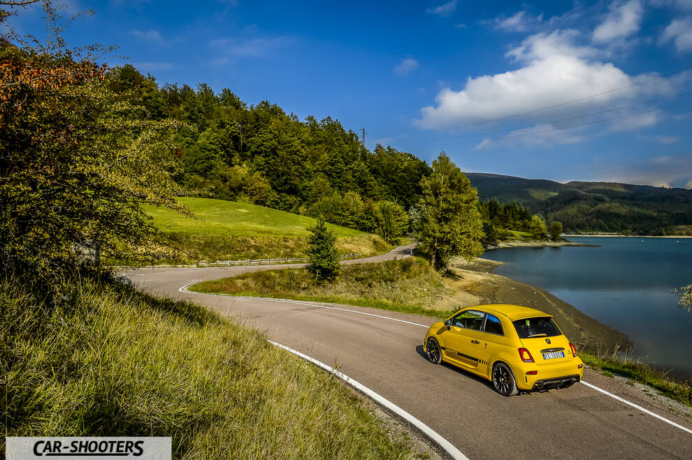 Abarth 595 Competizione – rear three-quarter, yellow on a winding coastal road
