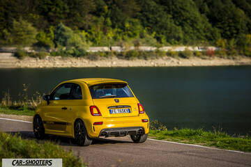 Abarth 595 Competizione – rear three-quarter, yellow on a road by water
