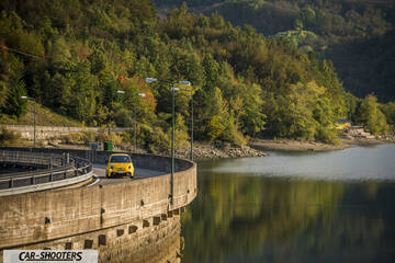 Abarth 595 Competizione – front three-quarter, yellow on a road near water