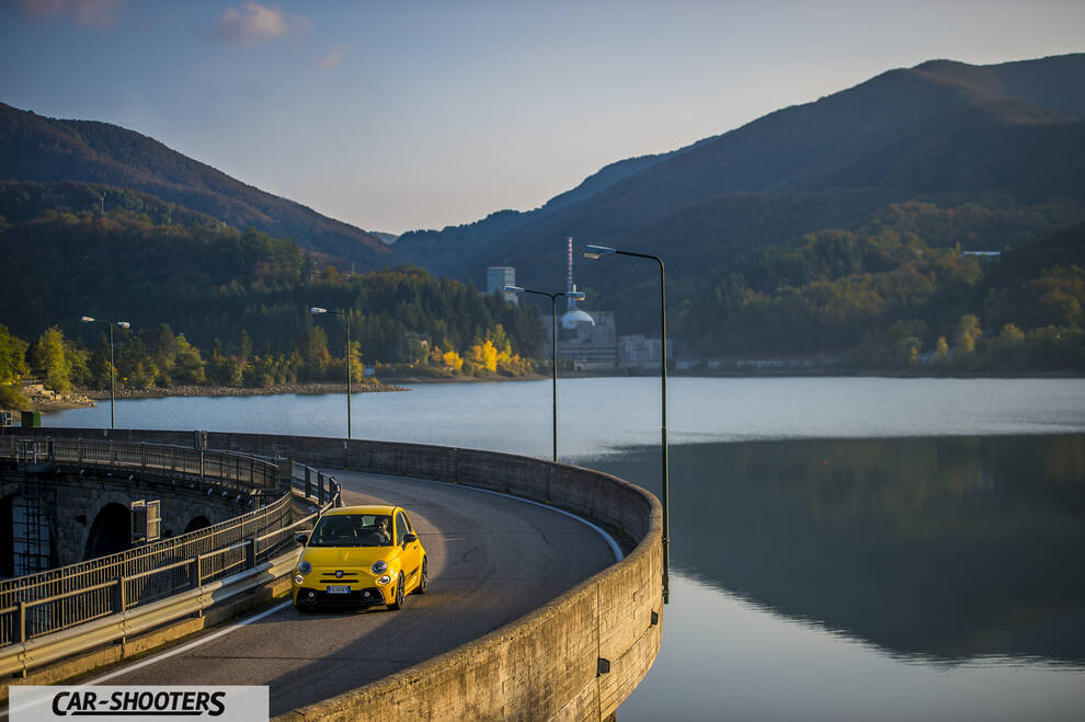 Abarth 595 Competizione – front three-quarter, yellow against a mountain backdrop
