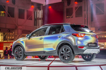 rear three-quarter, iridescent on a display platform