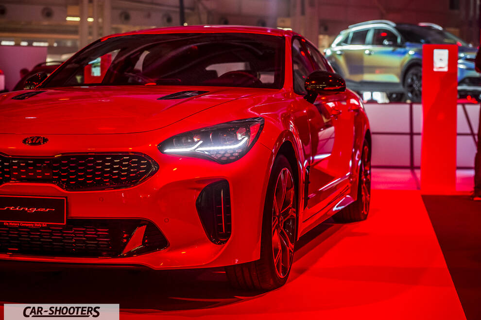front three-quarter, red at a car show