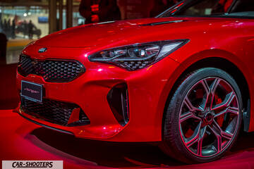 front three-quarter, bright red at an auto show
