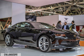 front three-quarter, black at a motor show
