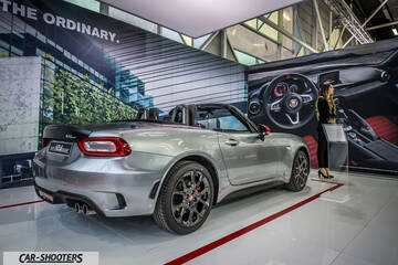 rear three-quarter, silver at an indoor auto show