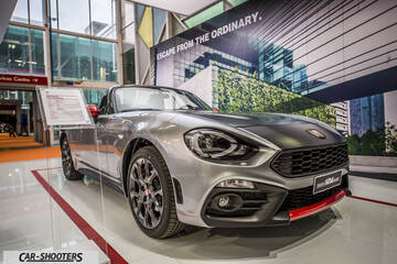 front three-quarter, silver metallic in an indoor showroom