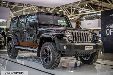 front three-quarter, black at an indoor auto show
