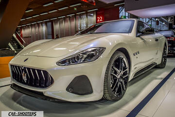 front three-quarter, white on an auto show floor