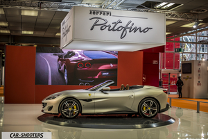 side profile, silver metallic on an auto show stand