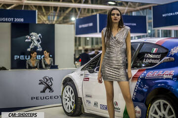 side profile, white and blue at an auto show